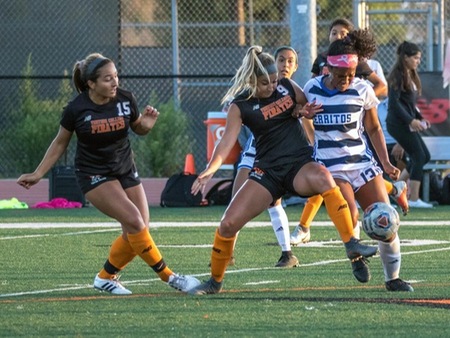 Pirate defender Sammy Zanini (9) fights for the ball while defender Natalie Lansberg (15) looks on during VC's 1-0 victory over Cerritos Monday night at the Sportsplex. (photo by Felix Cortez)