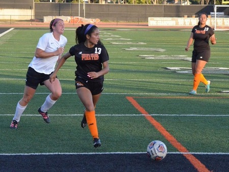 Pirate midfielder Aleesa Ramirez (130 searches for the cross while Jacky Espinosa (19) looks on during VC's match with Moorpark Friday at the Sportsplex. Ventura dropped a 2-1 decision to the Raiders.
